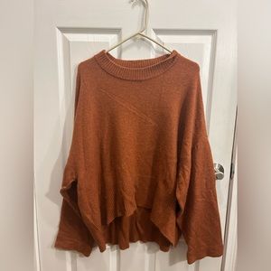 Woman’s burnt orange hi- low sweater